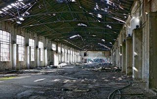 The interior of a run-down, abandoned industrial facility.