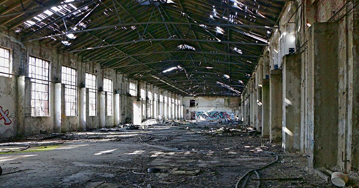 The interior of a run-down, abandoned industrial facility.